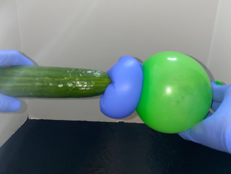 A homemade fleshlight using a party balloon with a latex glove and lube inside.